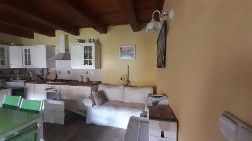 a living room with a white couch in a kitchen at Country House with four apartments in Drahov