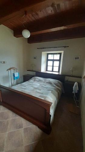a bedroom with a large bed with a window at Country House with four apartments in Drahov