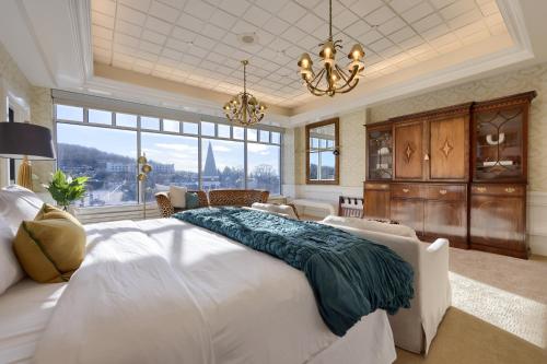 a large bedroom with a large bed and a chandelier at The Executive Suites and Events in Ephrata