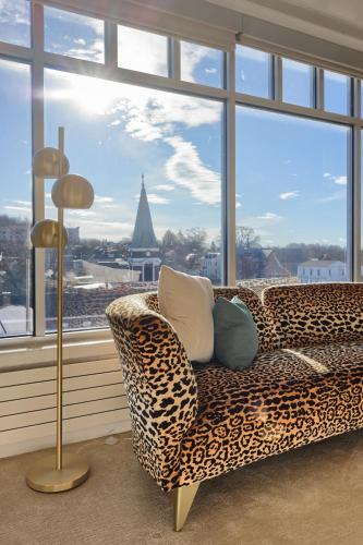 a leopard print couch in a room with a large window at The Executive Suites and Events in Ephrata