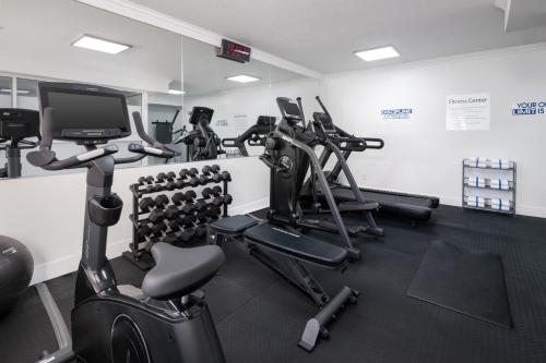 a gym with several treadmills and cardio machines at Holiday Inn & Suites San Mateo - SFO by IHG in San Mateo