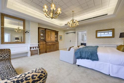 a large bedroom with a bed and a chandelier at The Executive Suites and Events in Ephrata