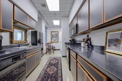 a kitchen with black counter tops and wooden cabinets at The Executive Suites and Events in Ephrata