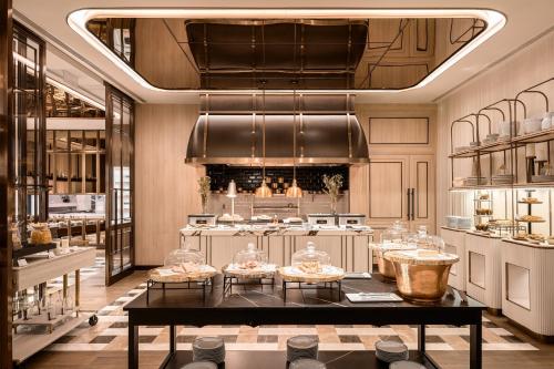 a large kitchen with a table in a room at InterContinental Bangkok Sukhumvit by IHG in Bangkok