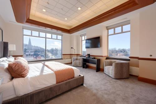 a bedroom with a large bed and a large window at The Executive Suites and Events in Ephrata