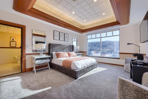 a bedroom with a bed and a large window at The Executive Suites and Events in Ephrata