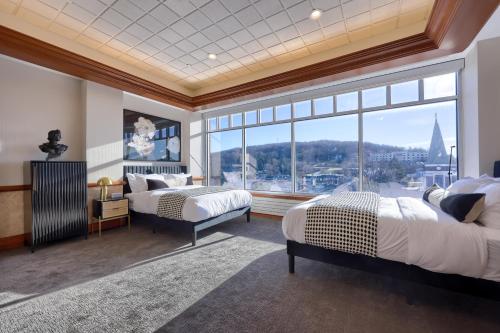 a bedroom with two beds and a large window at The Executive Suites and Events in Ephrata