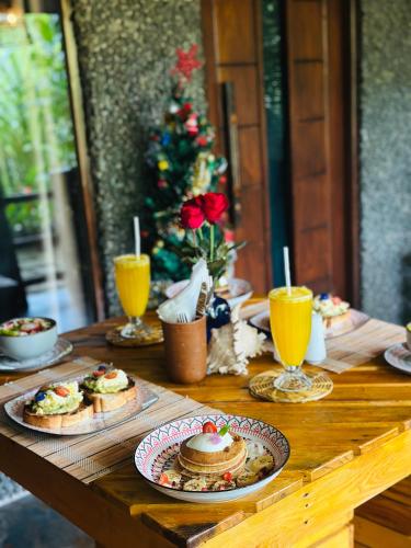 a wooden table topped with plates of food and drinks at La Casa Bella in Ella