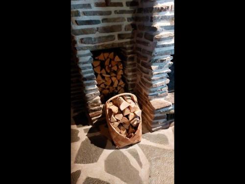 a stack of fire wood in a brick oven at Holiday Home Villihanhi by Interhome in Kuusamo