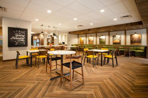 a restaurant with tables and chairs and a bar at Fairfield Inn & Suites by Marriott Greenville Spartanburg/Duncan in Duncan