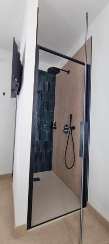 a shower with a glass door with a hose at Villa San Biagio Residence in Mason Vicentino