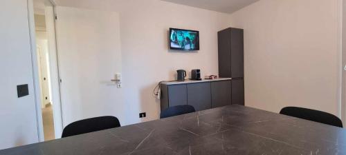 a room with a table and chairs and a tv on the wall at Villa San Biagio Residence in Mason Vicentino