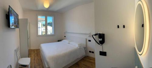 a white bedroom with a bed and a window at Villa San Biagio Residence in Mason Vicentino