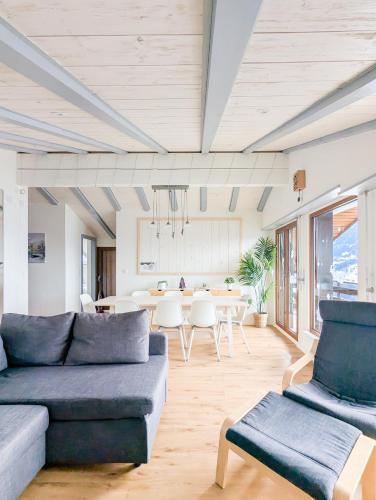 a living room with a couch and a table at Cocon familial avec vue au centre de Veysonnaz in Veysonnaz