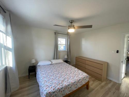 a bedroom with a bed and a ceiling fan at 10 Braddock Somers Point in Somers Point