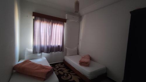 a small room with a couch and a window at Hostel Afgo Rooftop in Ouarzazate