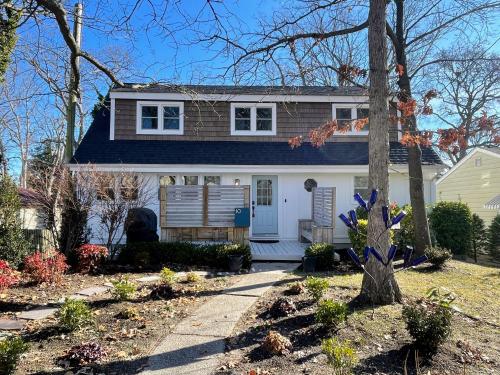 a white house with a blue roof at 10 Braddock Somers Point in Somers Point