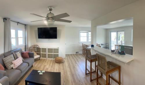 a living room with a couch and a ceiling fan at 10 Braddock Somers Point in Somers Point