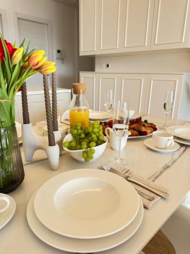 a dining room table with a plate of food and flowers at Luxury apartment L with jacuzzi in Split