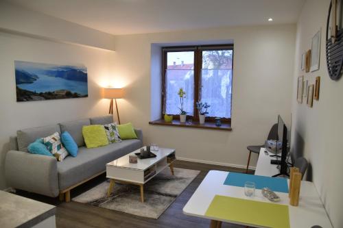 a living room with a couch and a table at Apartmán Dva na moto in Příbor
