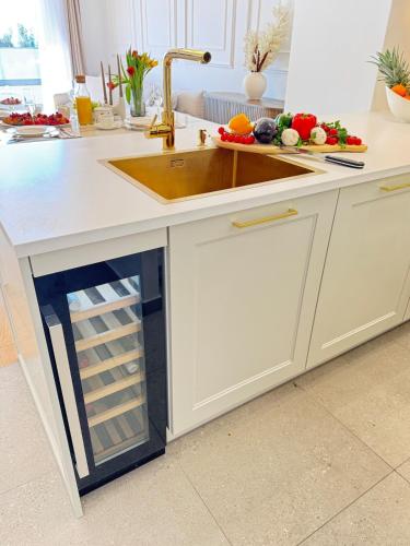 a kitchen counter with a sink and vegetables on it at Luxury apartment L with jacuzzi in Split