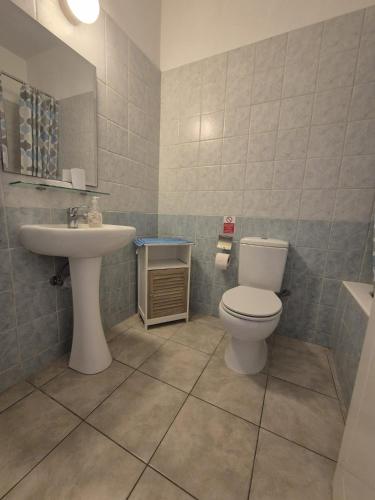 a bathroom with a toilet and a sink at 2 bedroom townhouse lower peyia paphos Cyprus in Peyia