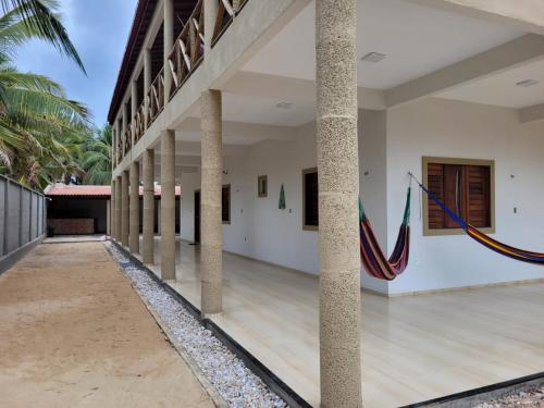 an empty courtyard of a building with columns at Casa da Bênção - Praia de Moitas in Amontada