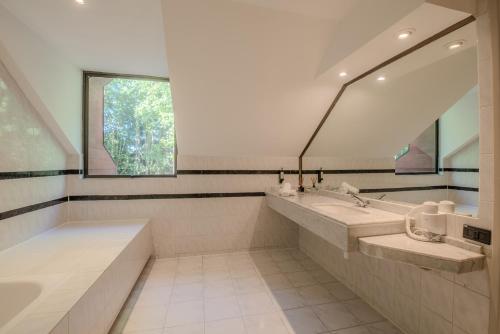 a bathroom with two sinks and a large mirror at Hotel Puerta del Sur in Valdivia