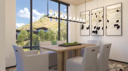 a dining room with a table and chairs and a window at The Sylvan Lodge at Snake River Sporting Club in Jackson