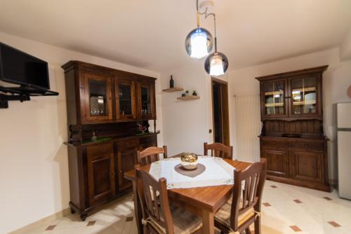 a kitchen with a table and chairs and a television at Villa Asia in Selva di Fasano