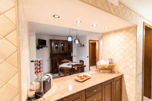 a kitchen with a counter top and a dining room at Villa Asia in Selva di Fasano