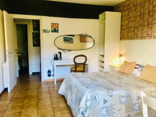 a bedroom with a bed and a desk with a mirror at Affittacamere Alle 5 Terre in Monterosso al Mare