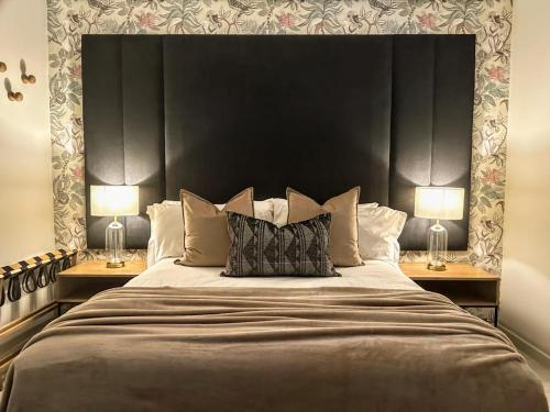 a bedroom with a large bed with two lamps at Zimbali Suite 512 in Ballito