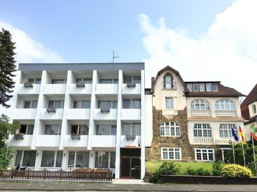 an apartment building with a white building at Hotel Hafez in Bad Salzuflen