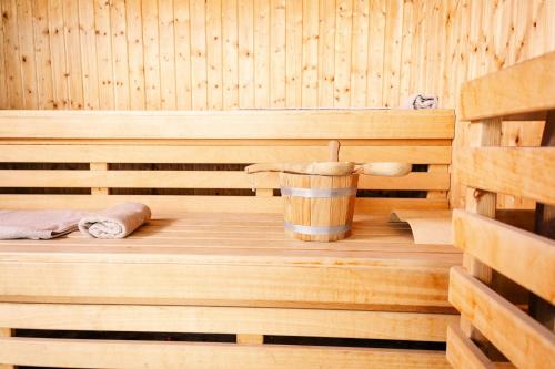 a wooden sauna with a bucket and towels at Noom Hotel Abidjan Plateau in Abidjan
