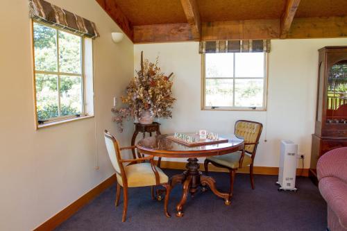a dining room with a table and chairs at Margrain Vineyard Villas in Martinborough 