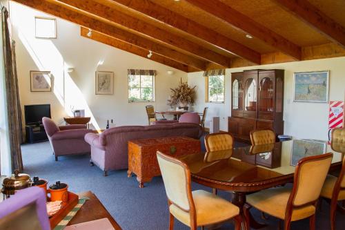 a living room filled with furniture and a table at Margrain Vineyard Villas in Martinborough 