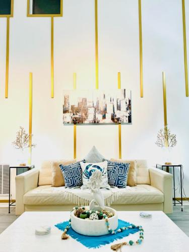 a living room with a couch and a table at Coastal Retreat Near Pineville and CLT in Charlotte