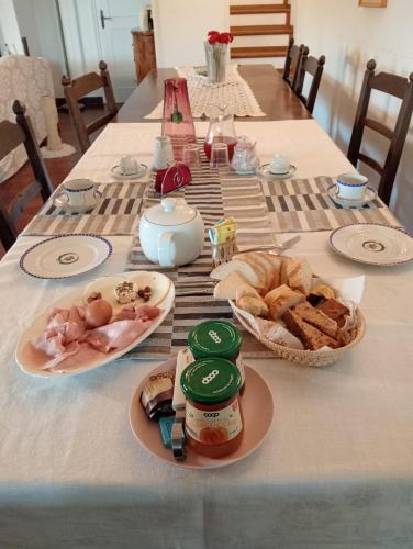 a table with bread and other food on it at Quarto di villa in Granarolo dellʼEmilia