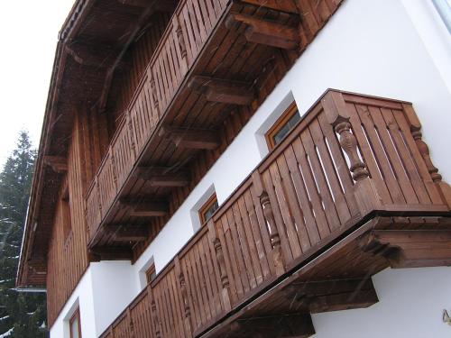 a pair of wooden balconies on a building at Pension Pek in Kubova Huť