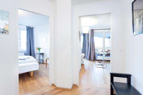 a white apartment with a bedroom and a living room at The Maybach - rooftop living XBerg, 1BR, 1 living room, group & family friendly, 2 - 4 Guests in Berlin