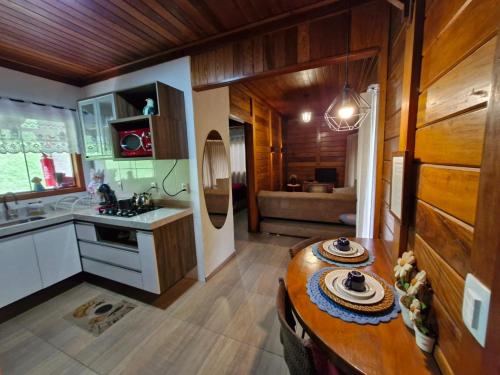 a kitchen with a table in the middle of a room at Pousada Villeta Di Itália in Santa Teresa