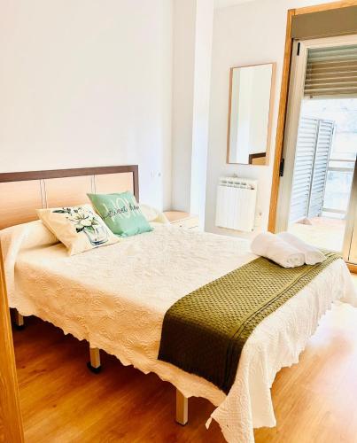 a bedroom with a large bed with green pillows at Baltar in Sanxenxo