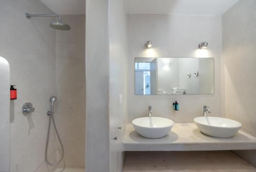 a bathroom with two sinks and a shower at Flisvos Beach Apartments in Naxos Chora
