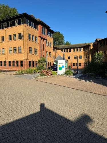 a shadow of a building on a brick street at Ivie's Place in Taunton