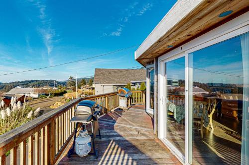 a balcony with a view of a train yard at Carousel House in Pacific City in Pacific City
