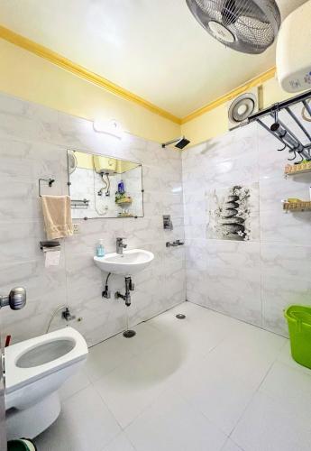 a bathroom with a sink and a toilet and a shower at Pearl of Nature By Nyra in New Delhi