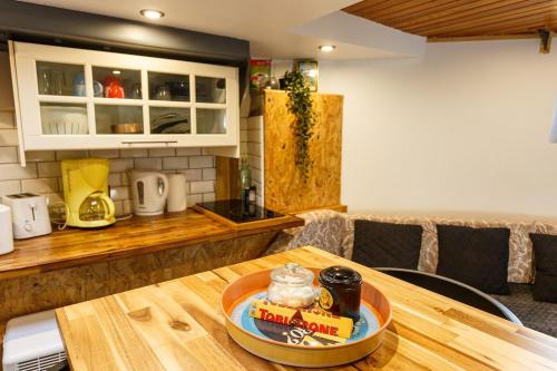 a kitchen with a table with a bowl of food on it at Péniche de charme avec jacuzzi sur canal du midi in Toulouse