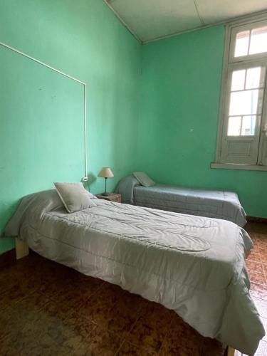 a bedroom with a large bed and a window at Casagrande Navarro in Navarro