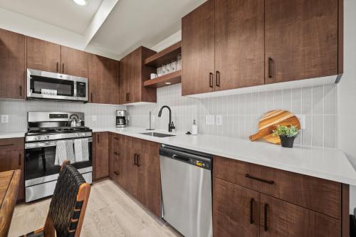 a kitchen with wooden cabinets and stainless steel appliances at Alpine Retreat at the Pointe Pt A106 in Eden
